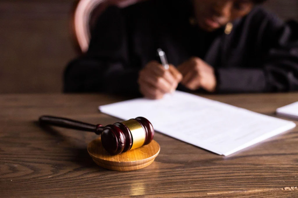 Judge signing court documents in a firearm rights restoration NC petition hearing